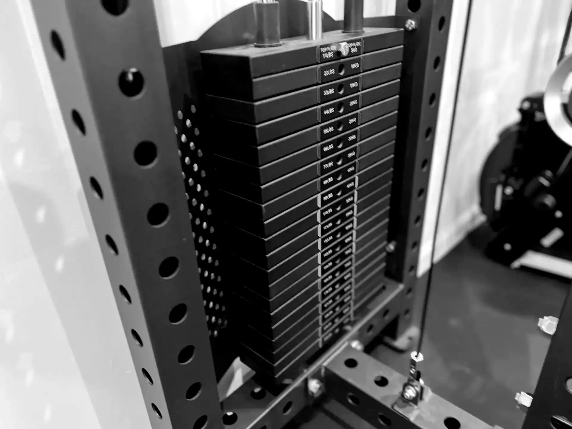 LaPlant Fitness Personal Training Studio Close-up of a professional cable machine weight stack in black and white at LaPlant Fitness private gym in Marin.