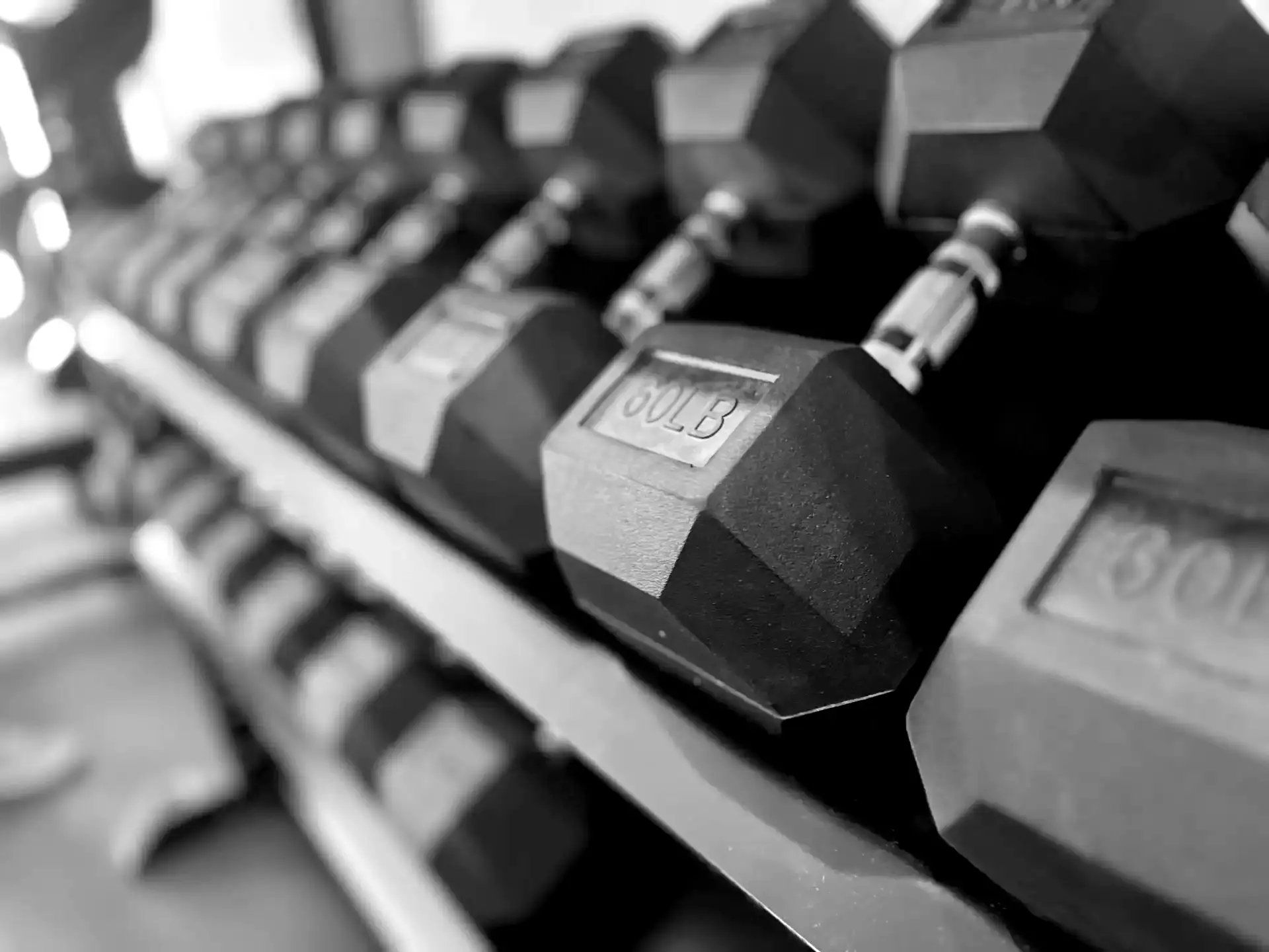 LaPlant Fitness Personal Training Studio A selective focus, black and white shot of a professional dumbbell rack at LaPlant Fitness private training studio in Marin, CA.