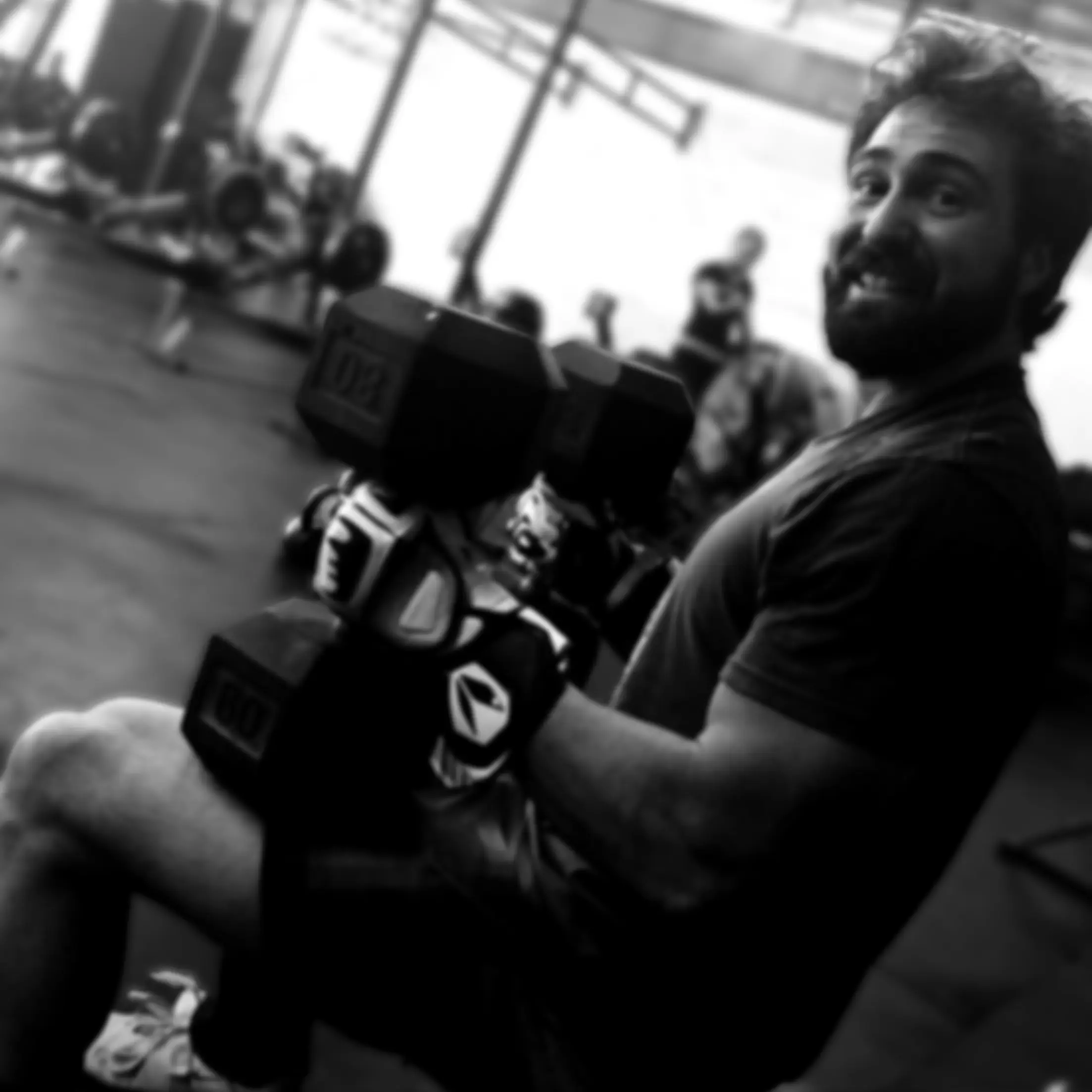 LaPlant Fitness Personal Training Studio Personal trainer Nick LaPlant seated on a weight bench holding heavy dumbbells during a workout at his private Marin fitness gym.